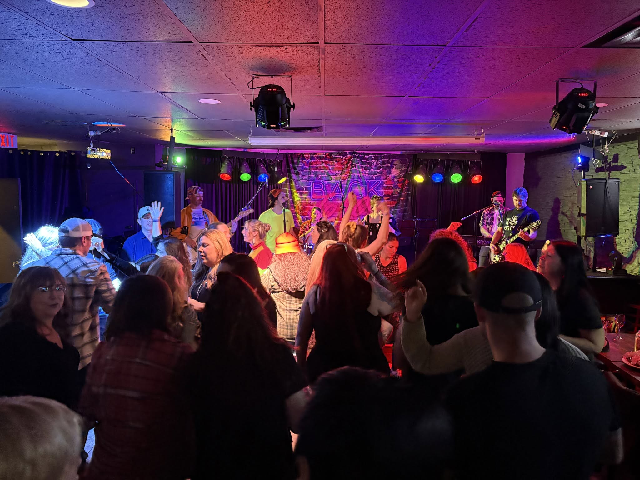 Crowd dancing at a live music event in Moncton