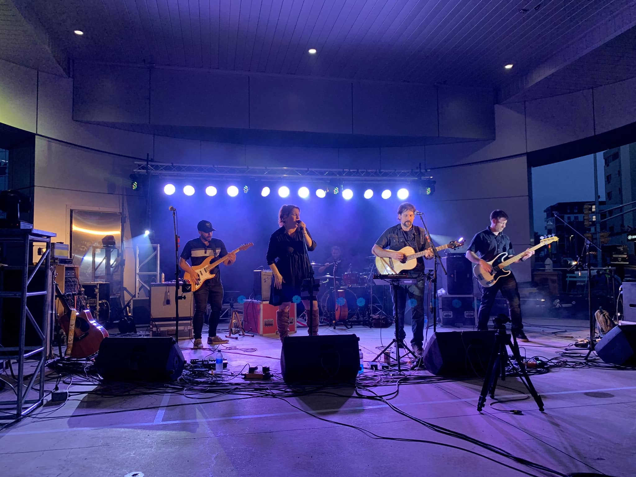 Band performing under stage lights at a Moncton event